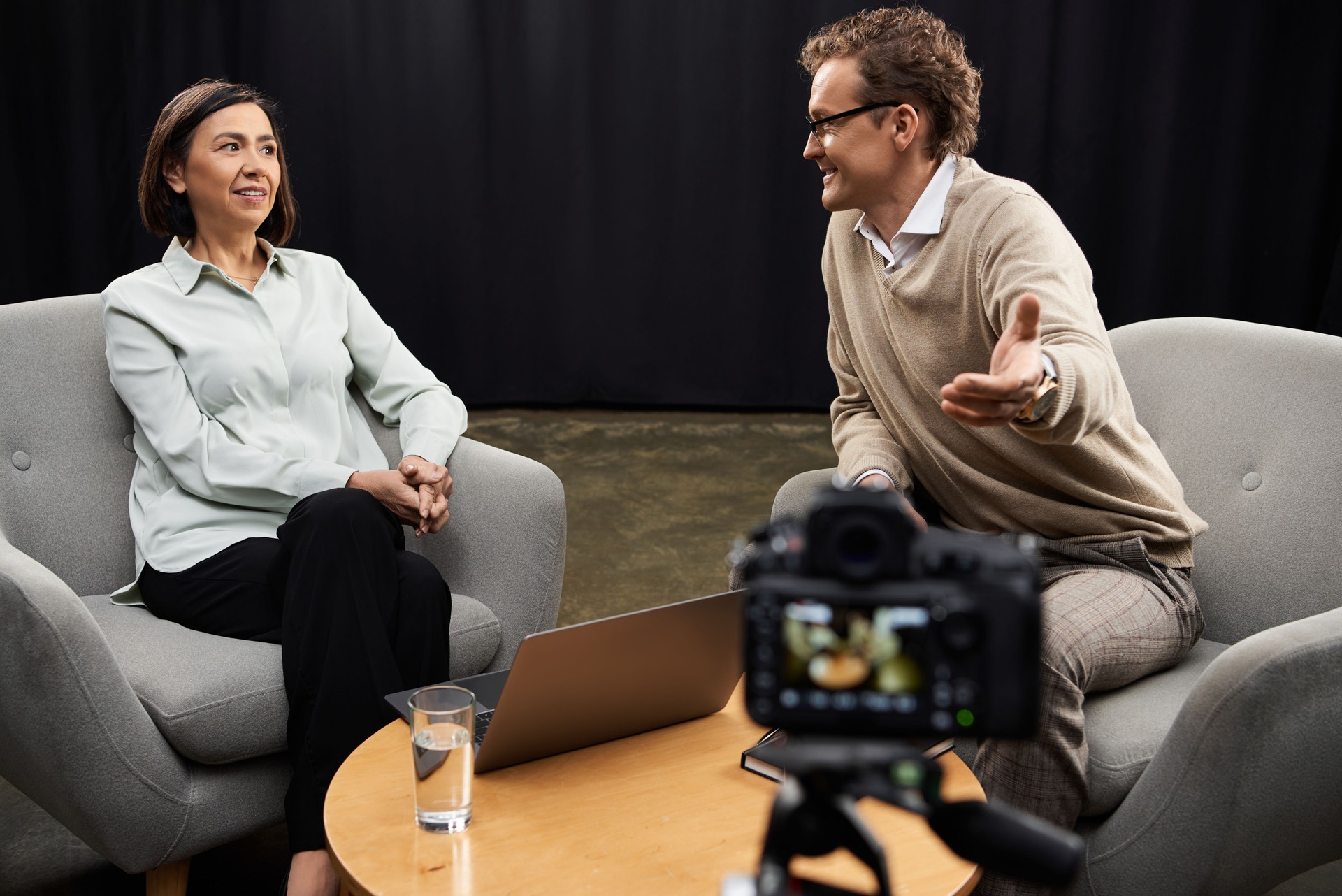 Dynamic journalist engages with an expert guest in a lively podcast studio discussion